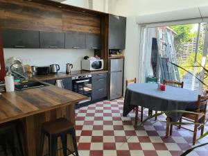 a kitchen with a table and chairs and a kitchen with a table and a counter at Chambre privée chez l'habitant en colocation dans agréable maison avec jardin - A private room in a shared house with garden in Bordeaux