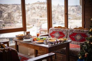 a table with food on it in a room with a window at Zeus Cave Suites in Göreme