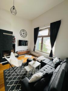 a living room with a couch and a tv at The View - ski to door in Bjelašnica