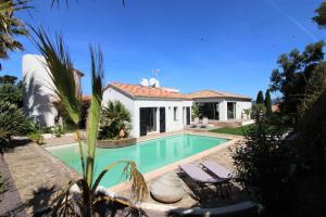 a villa with a swimming pool and a house at La madrague-Villa/Piscine vue Mer/Clim/Wifi in Hyères