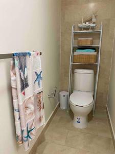 a bathroom with a toilet and a towel rack at Beautiful apartment, Playa del Carmen, Jacuzzi in Playa del Carmen