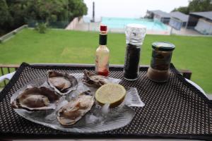 a plate of oysters and a lemon on a table at Tsitsikamma on Sea Poolside Cabanas - they are not tents in Witelsbos