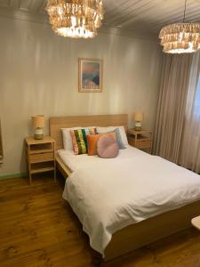 1 dormitorio con 1 cama con almohadas y lámparas de araña en HOUSE KA TEKKE 2, en Canakkale