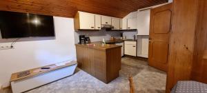 a small kitchen with white cabinets and a counter at Ferienwohnung Marlin in Sankt Gallenkirch
