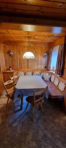 a dining room with a table and a couch at Ferienwohnung Marlin in Sankt Gallenkirch +8 photos