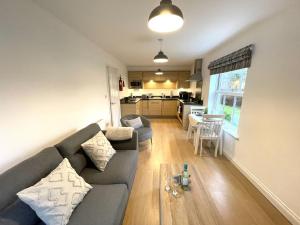 a living room with a couch and a table at Bliss On The Bay - Part of the The Bay Filey Holiday Village with pool, gym and direct beach access, pub, restaurant, tennis and meadows walks in Filey