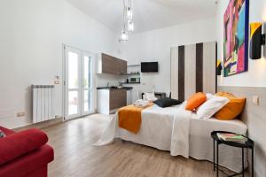 a bedroom with a large bed with orange and white pillows at Il Cortile dei Cantori in Lecce