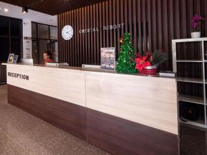 a christmas tree sitting behind a reception desk at Crystal Resort Korat in Nakhon Ratchasima