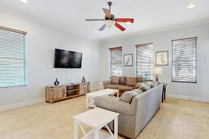 a living room with a couch and a flat screen tv at Villages of Crystal Beach Family Tides in Destin