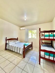 1 Schlafzimmer mit 2 Etagenbetten und einem Fenster in der Unterkunft MORADA GARAPEIRA in Guarda do Embaú