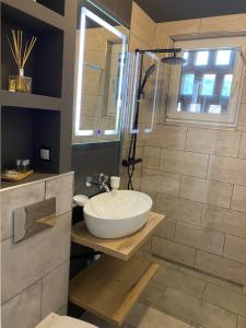 a bathroom with a sink and a shower at ApartLupeni in Lupeni