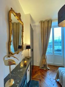 a bathroom with a mirror on a counter and a sink at Charming appartement with a view of the Saone in Mâcon