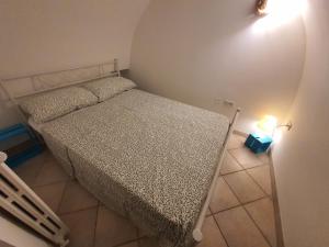 a small bedroom with a bed and a night stand at MI PUGLIA Casa vacanze in Putignano