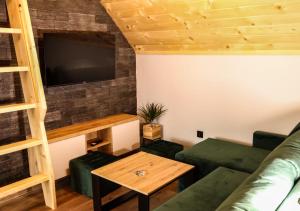 a living room with a couch and a table at Domek Parzenica Nowy Targ in Nowy Targ