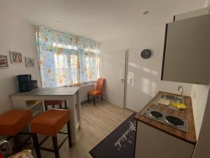 a small kitchen with a sink and a table at Ferienwohnung Sonnenblume in Memmingen