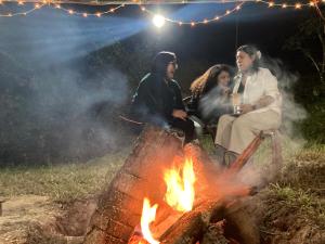 a group of people sitting around a fire at Art Mile Kalimpong in Kalimpong