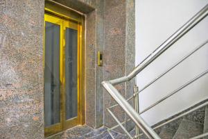 a yellow door on a building with stairs at 79600 The Premium Villa in New Delhi