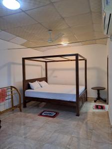 Un dormitorio con una cama con dosel en una habitación. en Royal Villa, en Ahangama