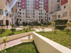 a courtyard in a large apartment building at Appartement S1 Jardins l aouina in Tunis