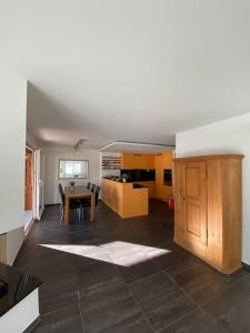 a living room with a table and a kitchen at WEF Appartement in Davos