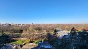 a view of a park with benches and a parking lot at Alloggio sul parco in Modena