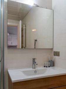 a bathroom with a sink and a mirror at Apartment in Tbilisi &ldquo;Green Budapest &ldquo; in Tbilisi City