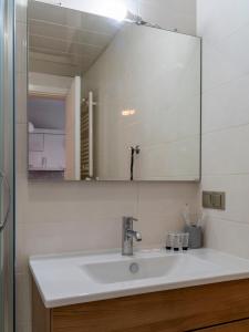 a bathroom with a sink and a mirror at Apartment in Tbilisi “Green Budapest “ in Tbilisi City