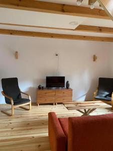 a living room with a couch and two chairs at Agroturystyka Łazory nad Tanwią 