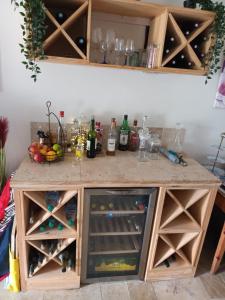 ein Weinschrank mit Weingläsern und Weinflaschen in der Unterkunft La Lavande in Nuaillé-sur-Boutonne + 9 Fotos