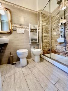 a bathroom with a toilet and a sink and a shower at Country B&B Piani del Mattino in Potenza