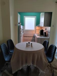 a kitchen with a table and chairs in a kitchen at Apartman Stanimirović 3 in Zaječar