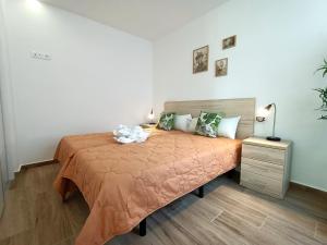 a bedroom with a bed with a orange bedspread at Los Alcazares Velapi - 0810 in San Javier +37 photos