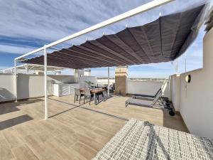 awning on a balcony with a table and chairs at Los Alcazares Velapi - 0810 in San Javier