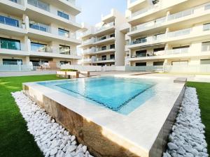 a swimming pool in front of a building at Los Alcazares Velapi - 0810 in San Javier