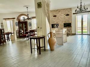 a living room with a vase on the floor at Country B&B Piani del Mattino in Potenza