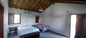 Katil atau katil-katil dalam bilik di Recanto das Flores