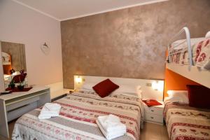 Voodi või voodid majutusasutuse Hotel Cima d'Oro toas