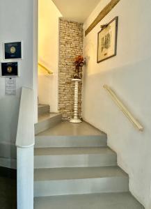 a staircase in a building with a brick wall at Country B&B Piani del Mattino in Potenza