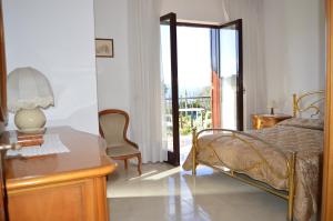 a bedroom with a bed and a dresser with a mirror at Mary's Dream - Villa overlooking Capri and Ischia in Sorrento Peninsula in Massa Lubrense