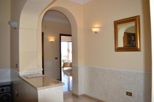 a hallway with an archway and a mirror on the wall at Mary's Dream - Villa overlooking Capri and Ischia in Sorrento Peninsula in Massa Lubrense +24 photos