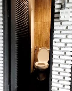 a bathroom with a white toilet in a room at La Malila Hostel in Udon Thani