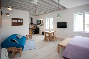 a bedroom and living room with a bed and a table at Stylish Theatre Apartments in Split