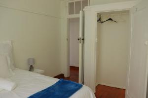 a bedroom with a bed and a door to a hallway at Grandborough in Durban