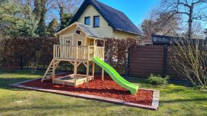 a playground with a slide in a yard at Feriendomizil-Stegemann in Trassenheide