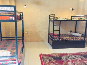 a room with two bunk beds and a rug at Jaisalmer hostel in Jaisalmer