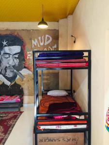 a bunk bed in a room with a mural at Jaisalmer hostel in Jaisalmer