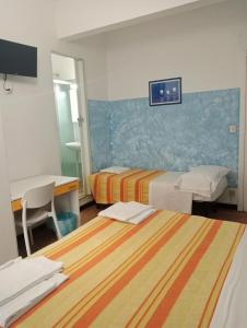 A bed or beds in a room at Albergo Belvedere