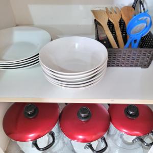 a shelf with plates and utensils in a kitchen at Apartamento viaje de estudio in Huancayo