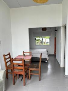 a room with a table and chairs and a bed at Complejo Las Palmeras in Colonia del Sacramento