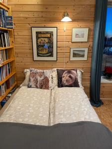 a bed in a room with a wall at Aurora exotic cabin in Vannareid